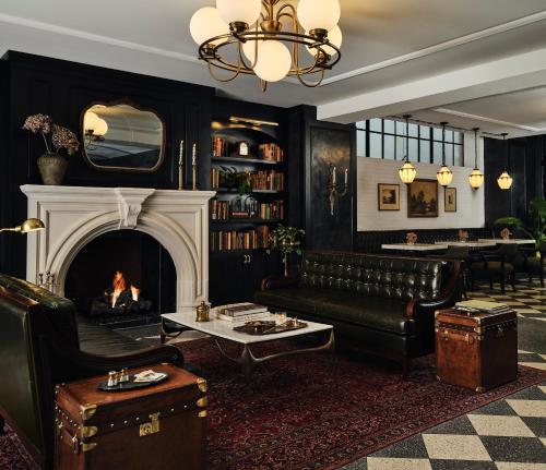 a living room with a couch and a fireplace at Hotel 1928 in Waco