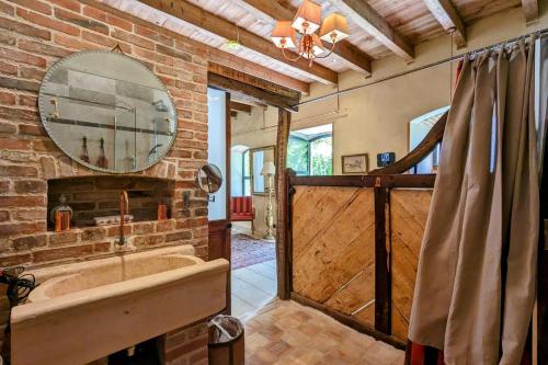 a bathroom with a large mirror and a bath tub at L'Ecurie Former stable with charm and light in Ingrandes