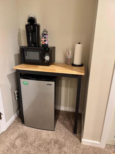 a small refrigerator under a table with a microwave at Killington Center 131 in Killington
