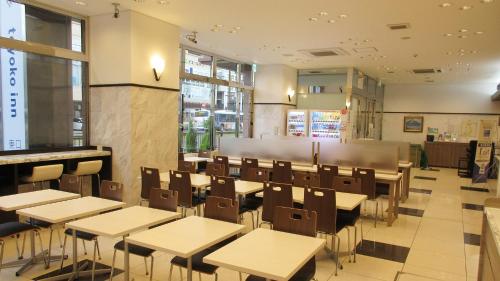 a dining room with tables and chairs in a restaurant at Toyoko Inn Kagoshima chuo eki Higashi guchi in Kagoshima