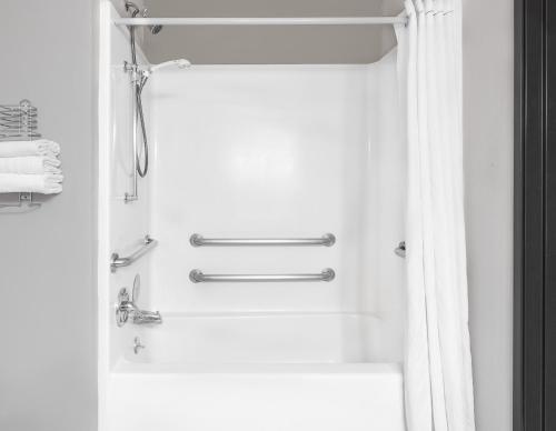 a bathroom with a shower with a shower curtain at Super 8 by Wyndham Bedford DFW Airport West in Bedford