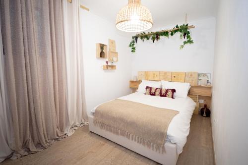 a bedroom with a bed and a chandelier at Douro Rural Home in Melres