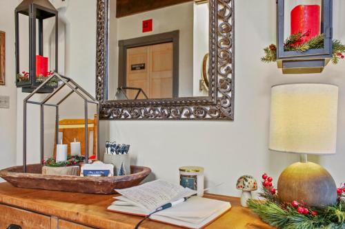a desk with a mirror and a lamp on it at Paper Mill Pines Bed and Breakfast in Shickshinny
