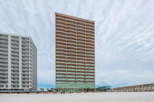 a tall building next to two large buildings at Phoenix Gulf Shores 903 in Gulf Shores