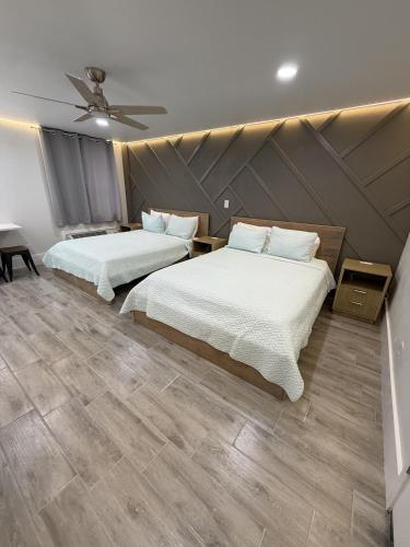 a bedroom with two beds and a ceiling at Renovated Beachfront Studio, New Kitchen, Pool in Daytona Beach