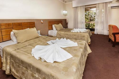 Exe Hotel Cataratas tesisinde bir odada yatak veya yataklar