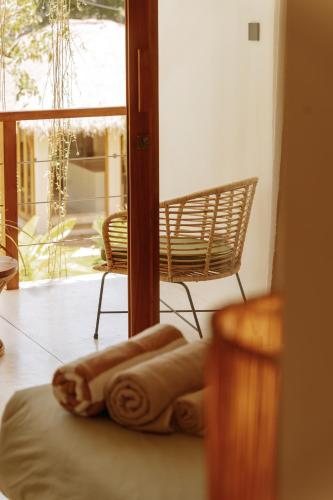 a towel sitting on a bed next to a window at Meraki in Polhena