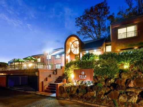 a building with a sign in front of it at リゾートホテル伊東山荘-Toki- in Ito