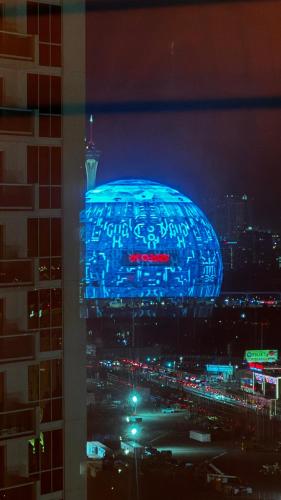 a building with a blue sign on it at night at MGM Signature-20-620 1Br 2Ba Balcony Suite in Las Vegas