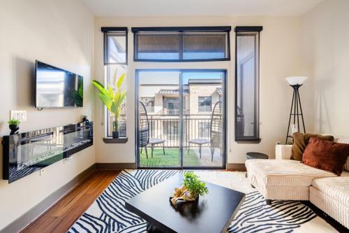 a living room with a couch and a table at Galleria King Luxury Suite - Walk to Mall - Pool View in Houston