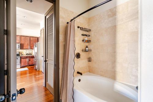 a bathroom with a white tub and a kitchen at Galleria King Luxury Suite - Walk to Mall - Pool View in Houston