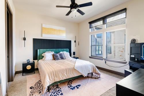 a bedroom with a bed and a ceiling fan at Galleria King Luxury Suite - Walk to Mall - Pool View in Houston