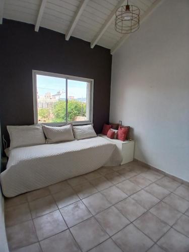 a large bed in a room with a window at Chiche del mar in Playa Unión