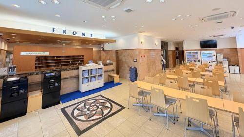 a large room with tables and chairs in it at Toyoko Inn Miyazaki Ekimae in Miyazaki