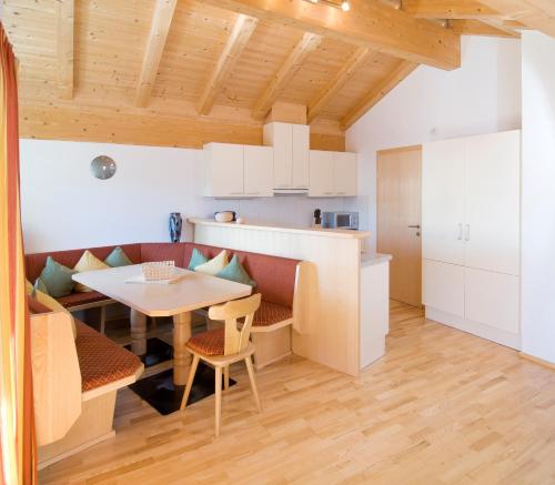 a kitchen with a table and a dining room at Appartementhaus Kurz in Westendorf