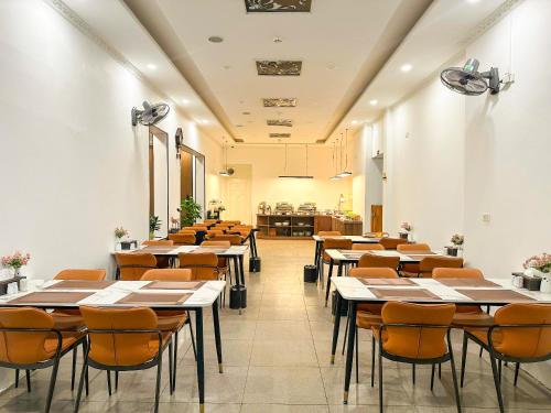 a row of tables and chairs in a restaurant at A25 Hotel - 185-187 Lò Đúc in Hanoi