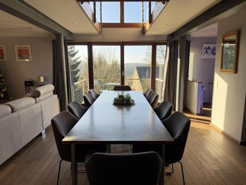 a dining room with a large table and chairs at Cottage in the heart of the Ardennes in Waimes