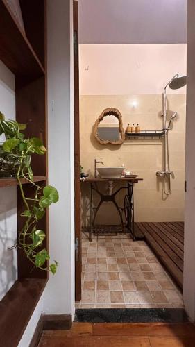 a bathroom with a sink and a table with a mirror at Leranda Bonita in Hue