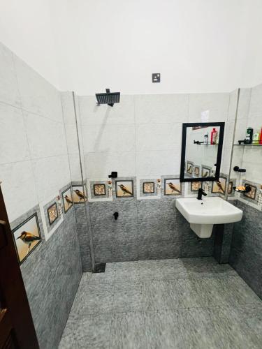 a bathroom with a sink and a mirror at silent beach House For Ever in Tangalle