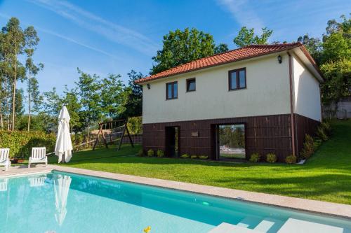 a house with a swimming pool in a yard at Carvalheira Country House - Gerês in Braga