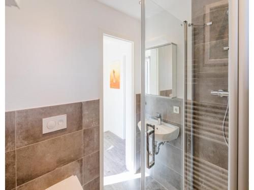 a bathroom with a sink and a shower at Bungalow im Campingpark in Waxweiler