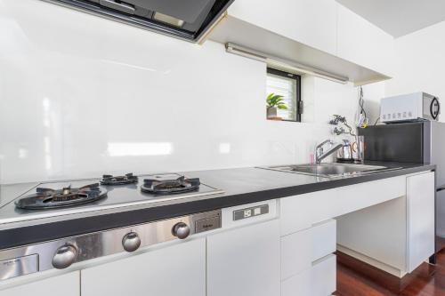 a kitchen with a stove and a sink at Pufuka Mukojima 1 in Tokyo