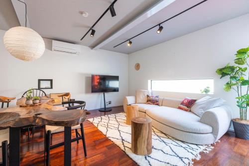 a living room with a white couch and a table at Pufuka Mukojima 1 in Tokyo
