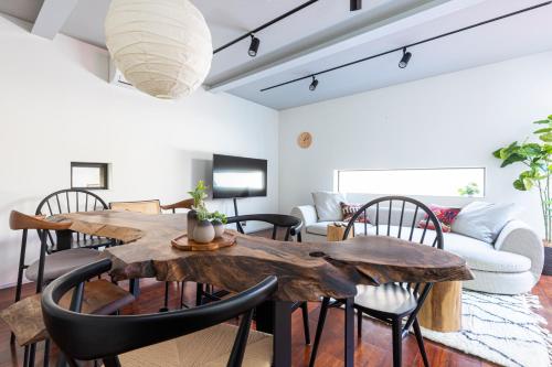 a living room with a wooden table and chairs at Pufuka Mukojima 1 in Tokyo