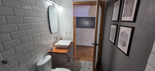 a bathroom with a sink and a toilet and a mirror at Modern Industrial Artsy Apt Remodel Secure in Matamoros
