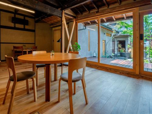 a dining room with a wooden table and chairs at 海野宿一棟貸し宿 上州屋 Unnojuku Joshuya in Tomi