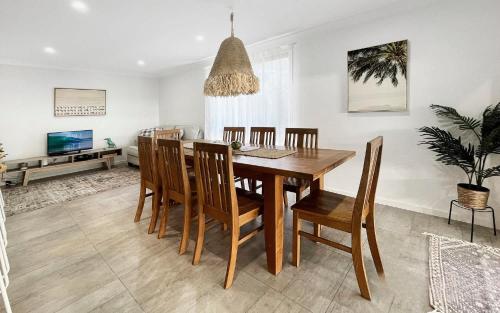 a dining room with a wooden table and chairs at Oak Flats Escape in Oak Flats