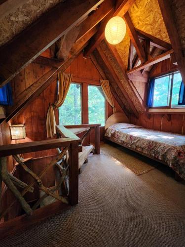 a room with two beds in a wooden cabin at Brisas del llaima in Melipeuco
