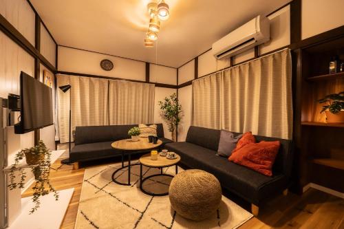 a living room with a couch and a table at -Shibamata House- 9-minute walk from Shibamata Station in Tokyo