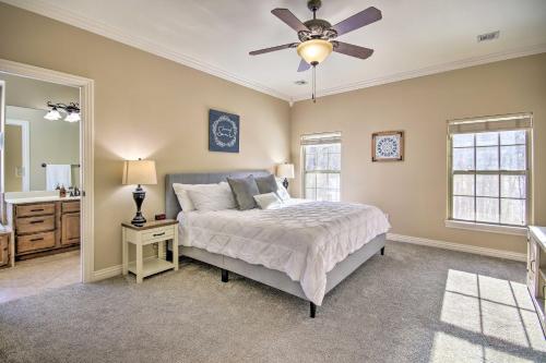 a bedroom with a bed and a ceiling fan at The Hub in Bella Vista