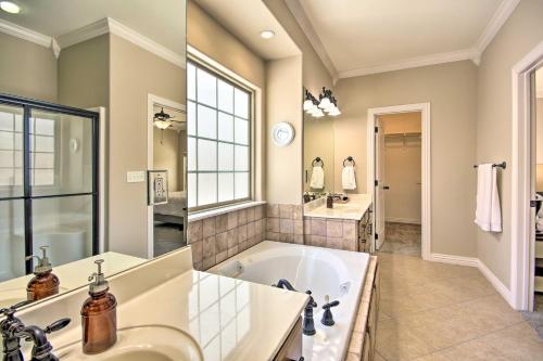 a large bathroom with a tub and a sink at The Hub in Bella Vista
