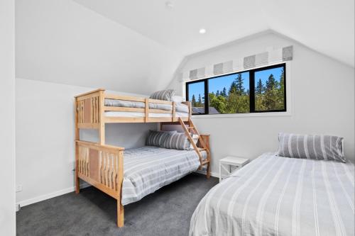 a bedroom with a bunk bed and a window at 44b Scarborough Terrace in Hanmer Springs
