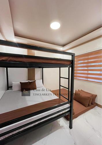 a bedroom with two bunk beds in a room at Lia Clarke Transient House in Nasugbu