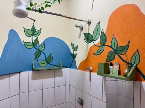 a bathroom with a blue dolphin painted on the wall at Loft Central Orgânico in Passos