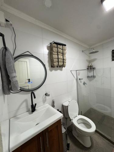 a bathroom with a sink and a toilet and a mirror at Casa Maipu in Corrientes