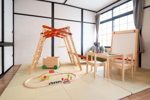 a play room with a ladder and toys on the floor at Biei Sakura Stay in Biei