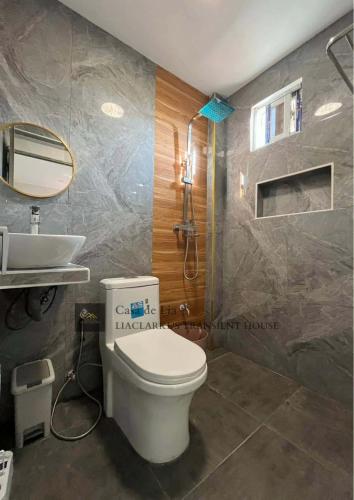 a bathroom with a toilet and a sink at Lia Clarke Transient House in Nasugbu