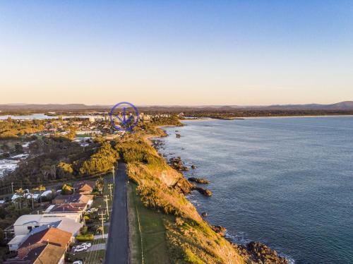 an aerial view of a city and the water at Surfspray 4 Pebbly Beach in Forster