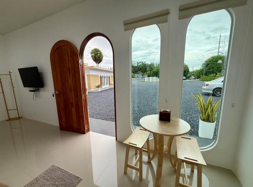 a room with a table and chairs and a window at Farinda Resort in Phangnga