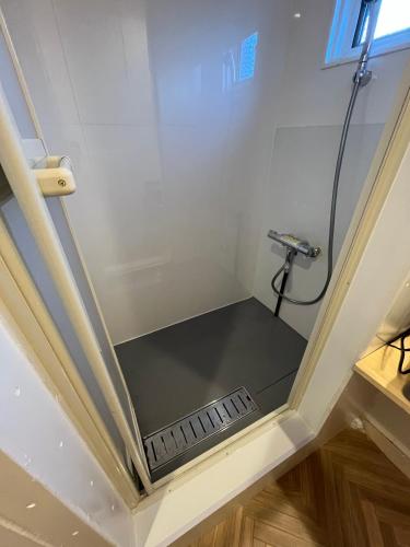 a shower in a bathroom with a glass ceiling at TomaReno Beppu-Kitahama in Beppu