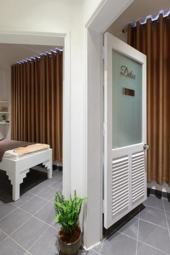 a room with a door with a bed and a couch at Alba Hotel in Hue