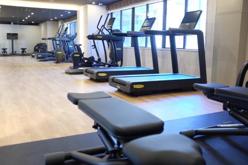 a gym with a row of treadmills at THE KNOT TOKYO Shinjuku in Tokyo