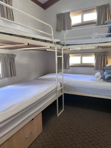 two bunk beds in a room with a window at Paynesville Holiday Park in Paynesville