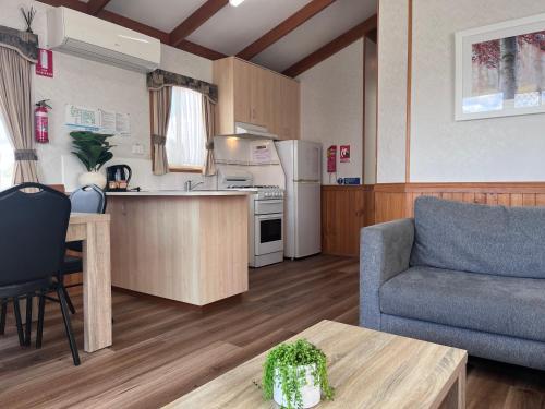 a kitchen and living room with a couch and a table at Paynesville Holiday Park in Paynesville