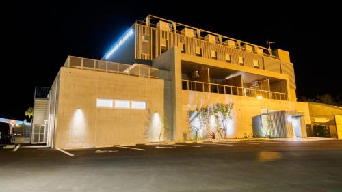 a building with a light on top of it at night at Fukiagehama Field Hotel in Ichikikushikino