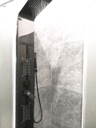 a shower with a glass door in a bathroom at Aureva Guest in Weligama